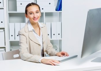 Attractive woman working in office on computer. Office work