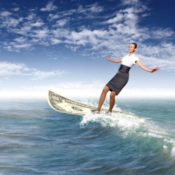 Image of a busineswoman surfing on the sea waves