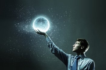 Businessman with moon. Young businessman holding moon planet in hand