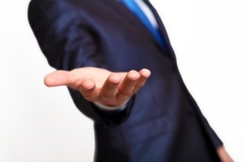 An empty hand of a businessman in blue suit
