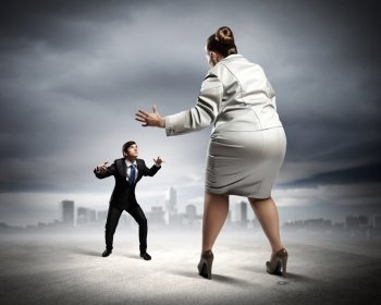 Business dispute. Image of businesspeople arguing and acting as sumo fighters against city background