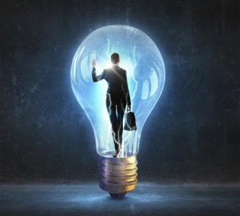 Woman inside of idea. Thoughtful businesswoman inside glass light bulb as brainstorming concept