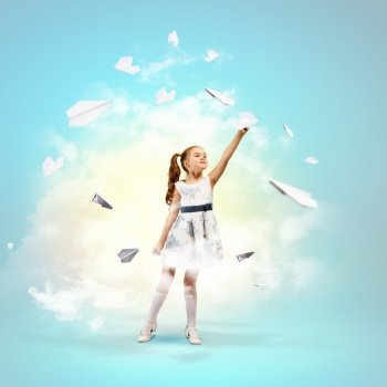 Little girl playing with paper airplane. Image of little pretty girl playing with paper airplane