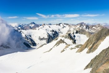 Snowy mountain peak. Mountain landscape with snow and clear blue sky