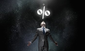 Interest symbol. Businessman with hands spread apart standing in light and percent sign above