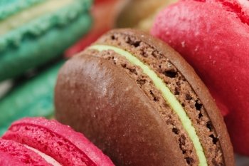 Set of delicious macaroons. Many colourful tasty macaroons in a row