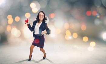 Funny businesswoman. Young funny businesswoman in suit against bokeh background