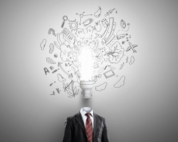 Head full of ideas. Unrecognizable businessman with light bulb instead of head