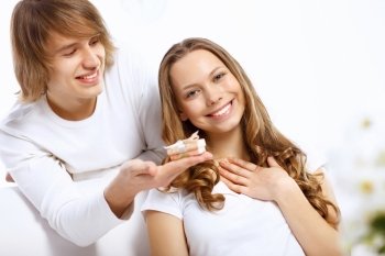 Young woman receiving a gift from her boyfriend