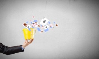 Businessman with bucket. Close up of businessman hand holding yellow bucket in hand