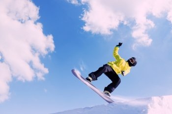 Snowboarding. Snowboarder making jump high in clear sky