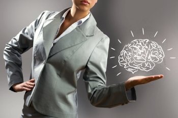 Smart thinking. Close up of business woman holding human brain in hand