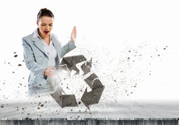 Recycle concept. Image of businesswoman crashing recycle stone symbol