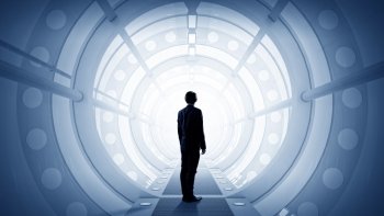 Man in futuristic interior. Businessman standing in virtual designed tunnel room 