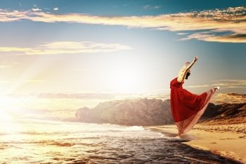 Female ballet dancer. Image of female ballet dancer against sunset background soaring above water waves
