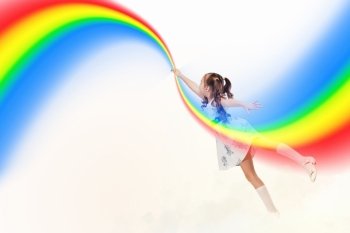 Little girl drawing rainbow. Image of little pretty girl drawing rainbow with finger