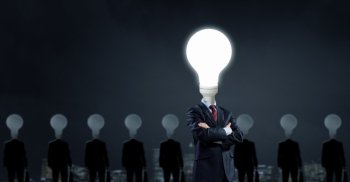 Stand out. Businessman in suit with light bulb instead of head