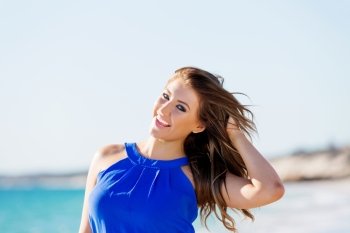 Young woman on the beach. Portrait of young pretty woman on summer day on the beach