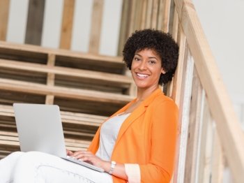 Portrait of young businesswoman in office holding laptop. Portrait of young businesswoman with laptop