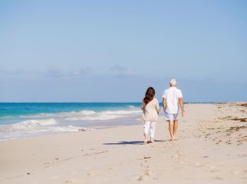 Couple walking on the beach. Walk along the waves