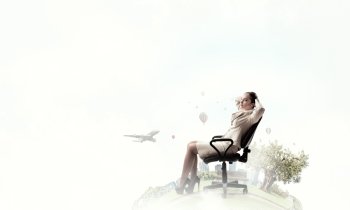 Businesswoman having rest in chair. Young relaxed businesswoman sitting relaxed in chair and dreaming