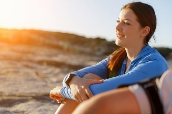 Couple in sport wear on beach. Young coulpe in sport wear sitting on beach
