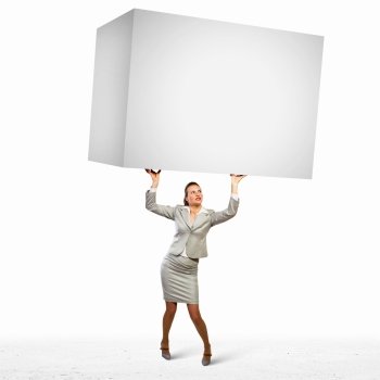 Businesswoman holding heavy cube. Image of business woman holding heavy white cube above head