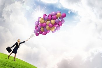 Woman with balloons. Young businesswoman with suitcase and bunch of colorful balloons