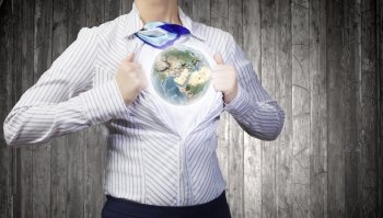 Business super power. Unrecognizable businesswoman opening her shirt like superhero. elements of this image are furnished by NASA