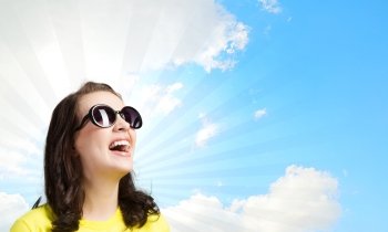 Positive teenager. Young girl teenager in sunglasses and yellow shirt