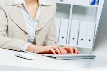 Close up of woman's hands working in office on computer