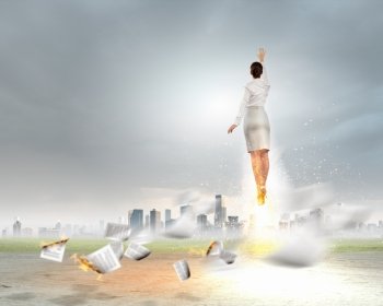 Super woman. Image of businesswoman flying up into sky