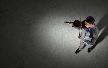 Businessman with violin. Top view of young businessman playing violin