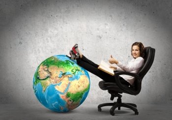 Education concept. Young businesswoman sitting in chair and reading book. Elements of this image are furnished by NASA
