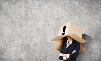 Woman with box on head. Unrecognizable businesswoman wearing carton box on head