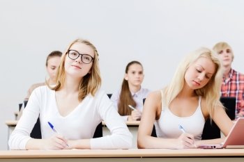 Young people sitting in classroom at lecture. Students at lesson
