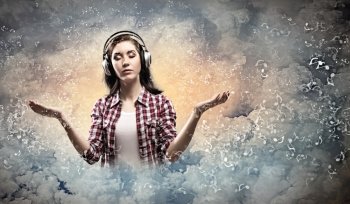 Young woman with headphones. Image of young pretty woman with headphones meditating