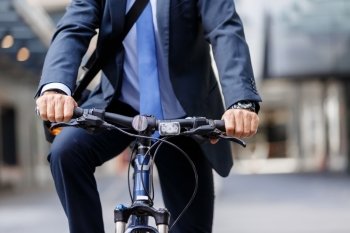 Successful businessman riding bicycle. Successful businessman in suit riding bicycle 