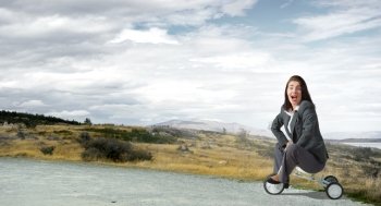 Woman riding bicycle. Young pretty businesswoman riding three wheeled bike