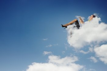 Businesswoman lying on clouds. Image of businesswoman lying on clouds with tablet pc
