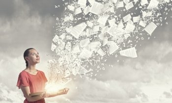 Reading books. Young girl with book in hands and pages flying in air