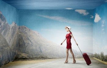 Woman in red. Young woman in red dress with red luggage