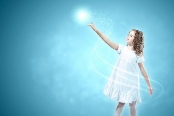 Child with magic light. Little girl with magic lights and shining around