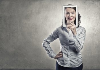 Woman with tablet expressing positivity. Smiling woman holding tablet instead of her face