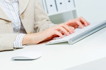 Close up of woman’s hands working in office on computer