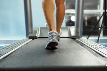 Running on treadmill. Image of female foot running on treadmill
