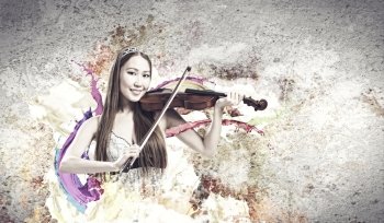 Woman violinist. Young pretty asian woman playing violin. Young talent