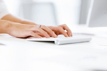 Female hands typing on the keyboard. Female hands typing on the white keyboard