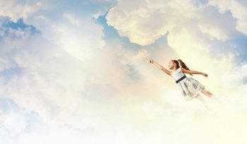 Little girl playing. Image of little pretty girl playing joyfully in the clouds