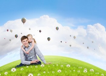 Happy parenting. Happy family of father and daughter sitting on grass